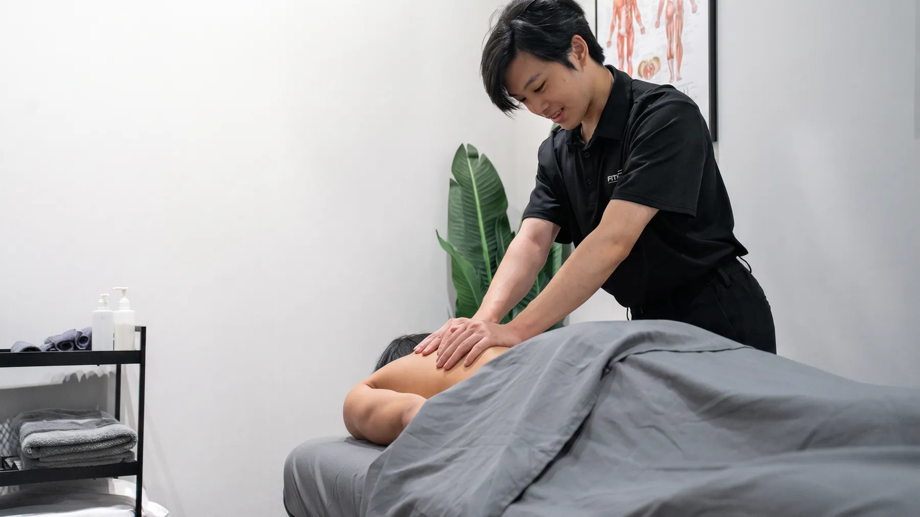 A Registered Massage Therapist treating a patient during a session at Fittopia Health Care.